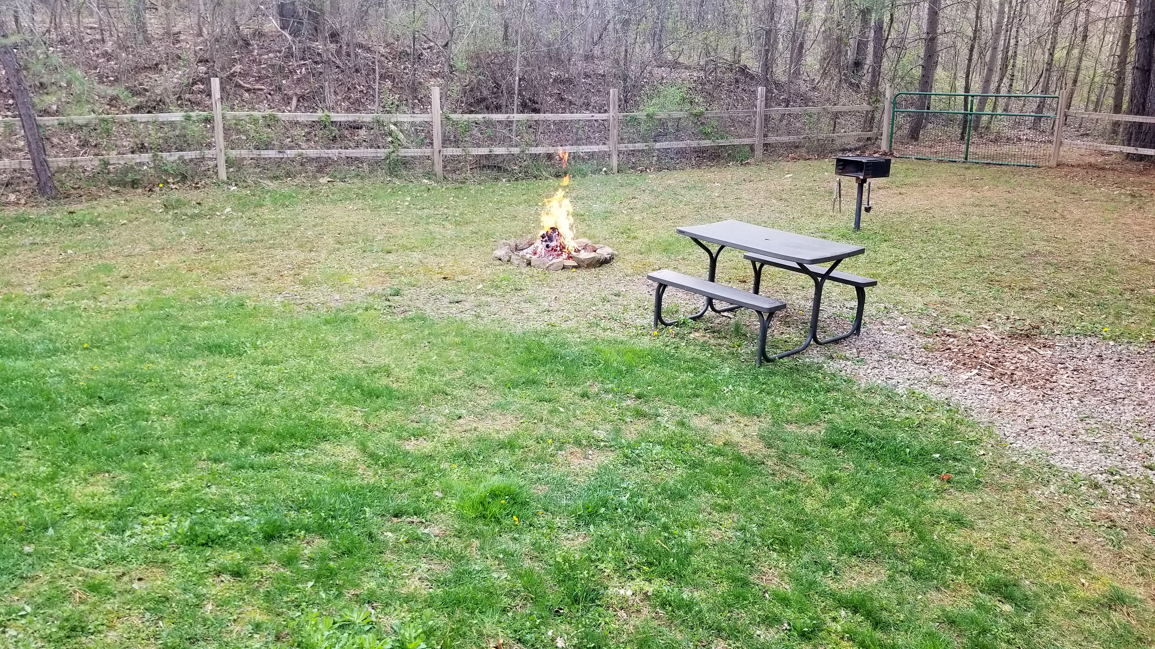 Photo 2175_7829.jpg - Fenced in Backyard with fire pit, picnic table, and charcoal grill